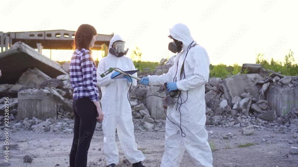 portrait scientists in protective suits and masks and dosimeter ,measure radiation and affected people portrait scientists in protective suits and masks and dosimeter ,measure radiation and affected people