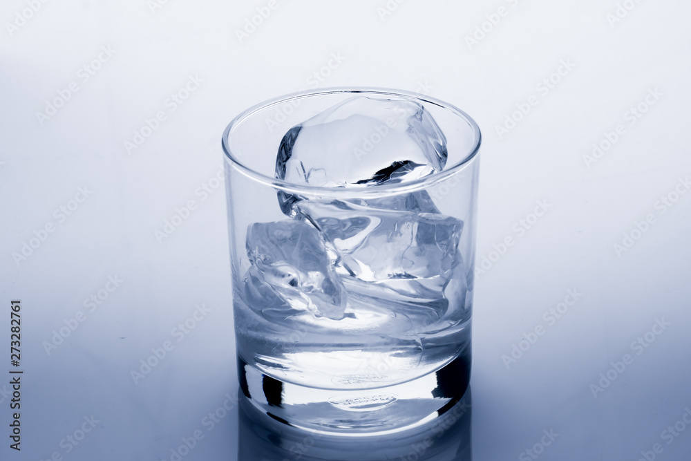 Ice cube melts in studio: Global warming concept Ice cube melts in studio: Global warming concept