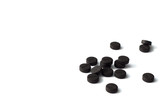 Handful absorbent carbon tablets on white background, right side, copy space on a left