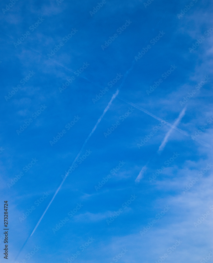 Condensation trail of passenger aircraft in form of a lattice in the sky.