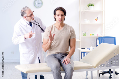 Young male patient visiting old doctor 