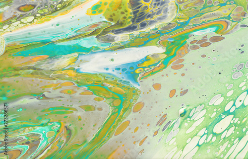 photography of abstract marbleized effect background. yellow, green and white creative colors. Beautiful paint