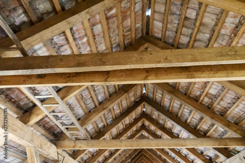 Wooden ladder lies on the old attic