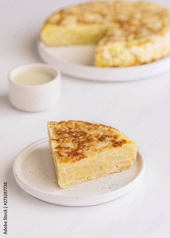 Tortilla Spanish omelette made with eggs and potatoes  on  served with traditional mayonnaise .