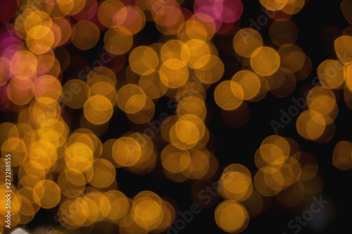 Abstract blurred and bokeh of reflection lighting of yellow led light bubs on black background.