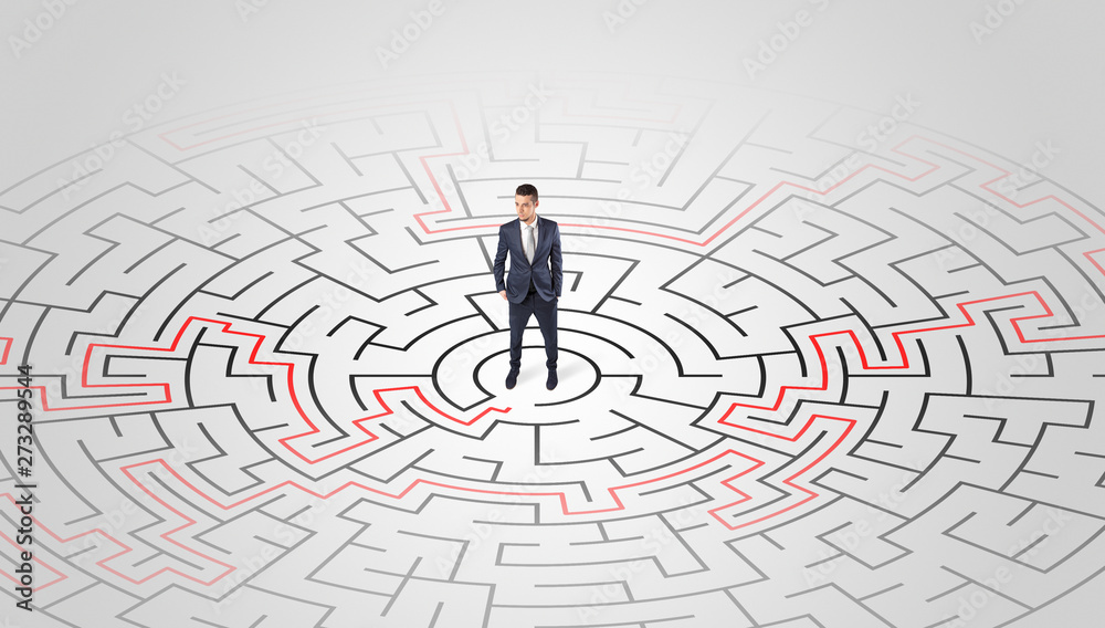 Young entrepreneur standing in a middle of a labyrinth with the solution
Young entrepreneur standing in a middle of a labyrinth with the solution