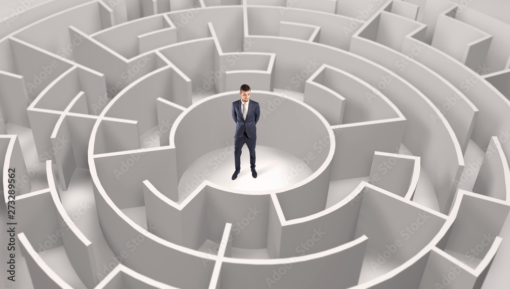 Young businessman standing in a middle of a 3d round maze
Young businessman standing in a middle of a 3d round maze