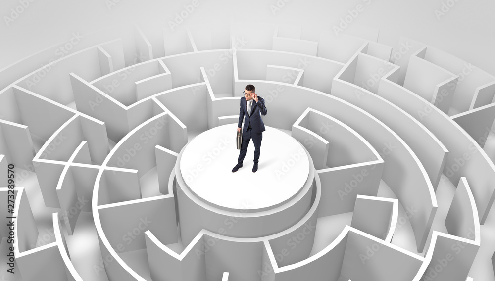 Businessman standing on the top a maze and looking through
Businessman standing on the top a maze and looking through