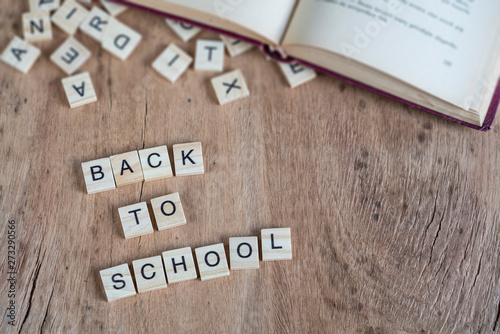 back to school template with cube letters and book on table