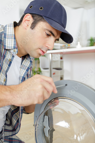 plumber with clipboard near washing machine