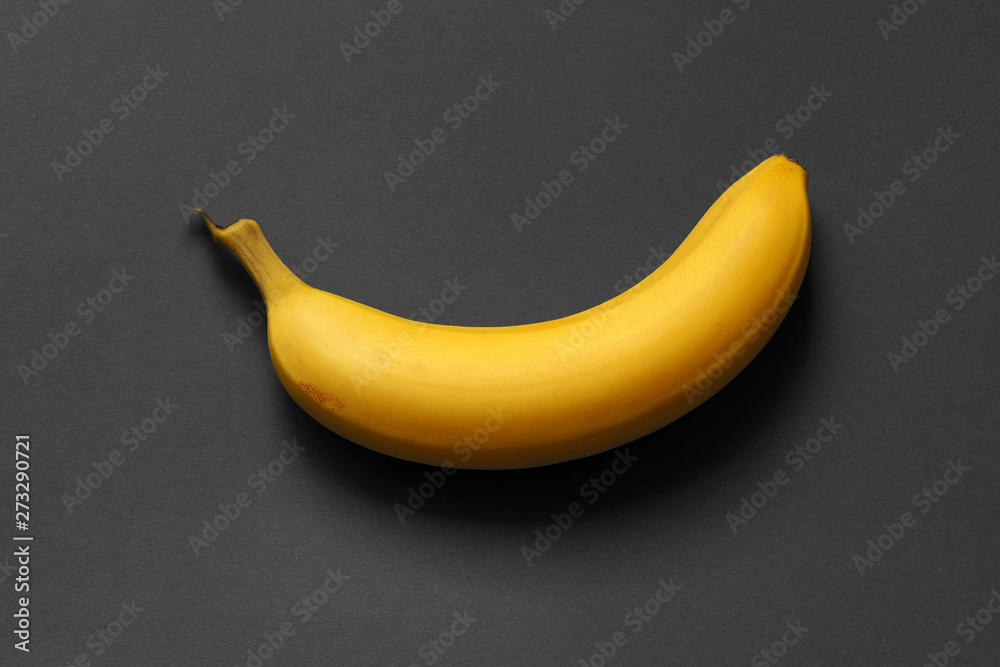 banana on a dark background. one ripe banana. banana on a dark background. one ripe banana.