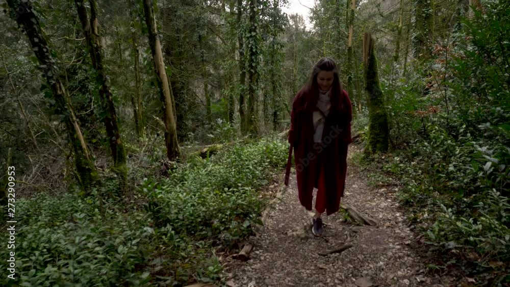 Woman walking on a path in the green Forest. Abkhazia Woman walking on a path in the green Forest. Abkhazia