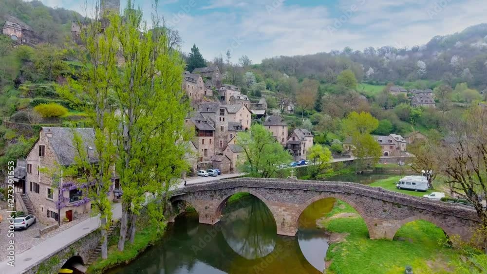 Chateau Belcastel and village with the famous arched bridge and river in the foreground in Aveyron, Southern France. Chateau Belcastel and village with the famous arched bridge and river in the foreground in Aveyron, Southern France.