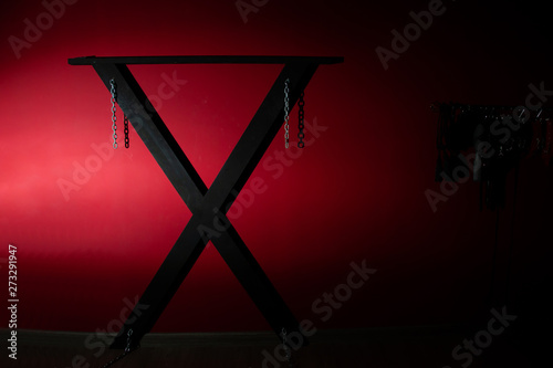  SM cross or Andreaskreuz is used in the BDSM scene on red background