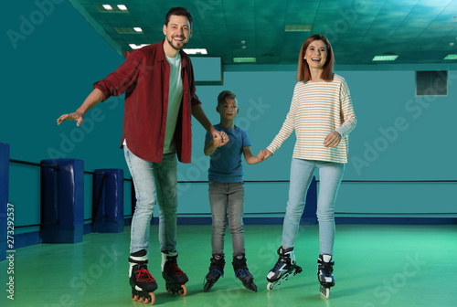 Happy family having fun at roller skating rink