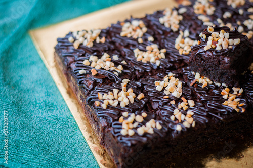 Chocolate Cake Brownie Squares Drizzled With Chocolate Nutella and Walnuts. Closeup view, selective focus