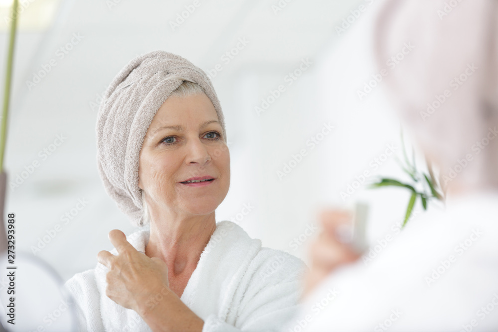 mature well groomed woman with bottle of perfumes mature well groomed woman with bottle of perfumes