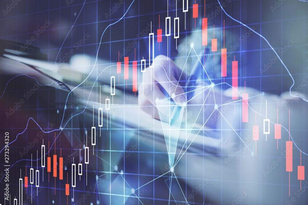 Financial forex graph displayed on hands taking notes background. Concept of research. Multi exposure Financial forex graph displayed on hands taking notes background. Concept of research. Multi exposure