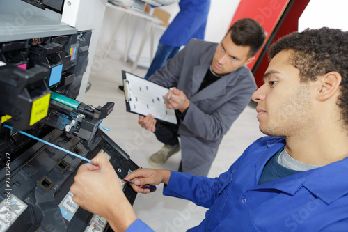 man repairing printer in professional school