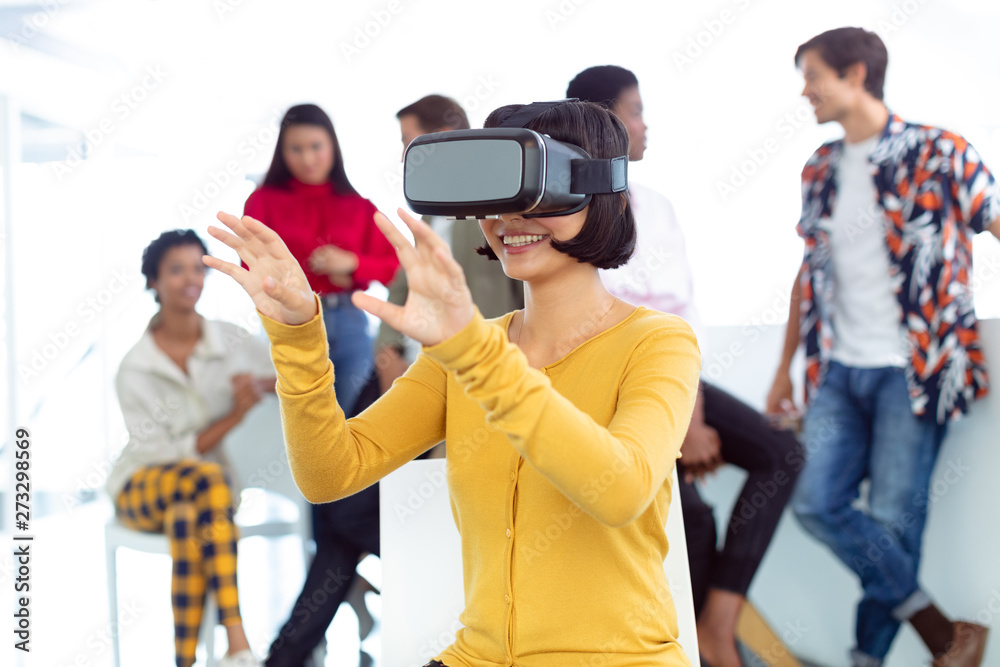 Young businesswoman using virtual reality headset in a modern office Young businesswoman using virtual reality headset in a modern office