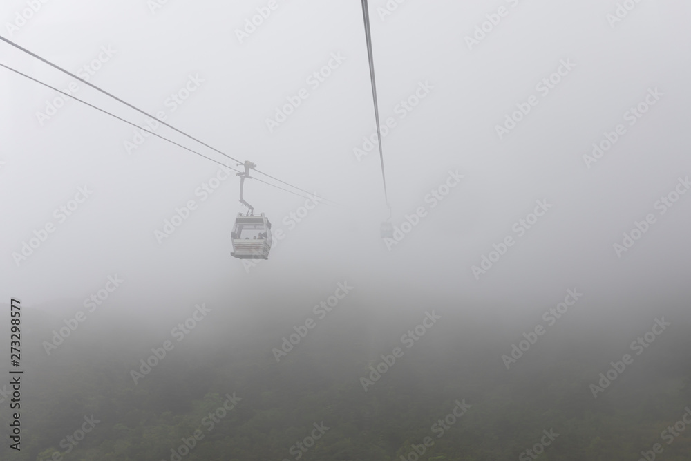 ngong ping 360 cable car on the green mountain landscape view in the rain season hong Kong ngong ping 360 cable car on the green mountain landscape view in the rain season hong Kong
