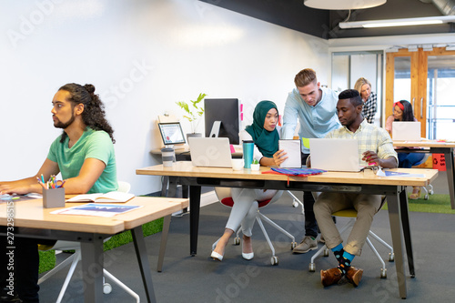 Business people working together at desk in a modern office