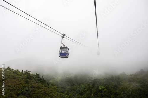 ngong ping 360 cable car on the green mountain landscape view in the rain season hong Kong