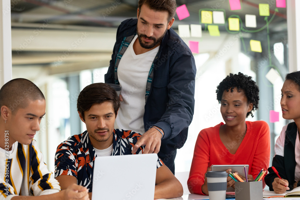 © WavebreakMediaMicro - Business people discussing over laptop in the conference room
