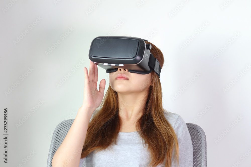 Young woman wearing virtual reality glasses at home. Young woman wearing virtual reality glasses at home.