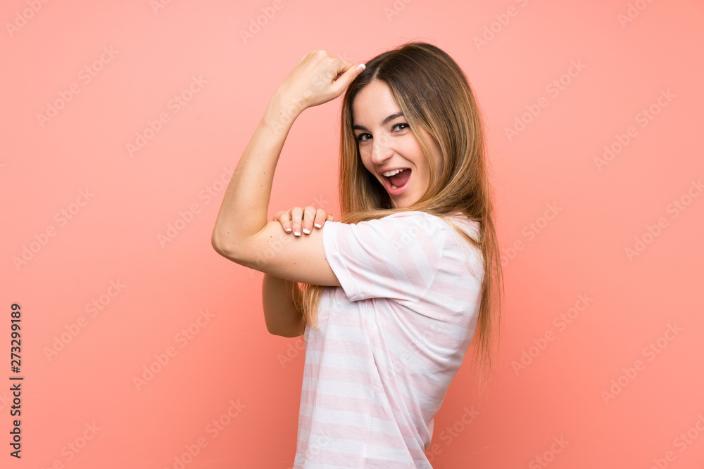 Young woman over isolated pink wall making strong gesture Young woman over isolated pink wall making strong gesture