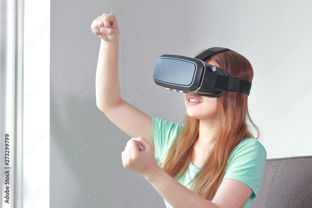 Young woman wearing virtual reality glasses at home. Young woman wearing virtual reality glasses at home.