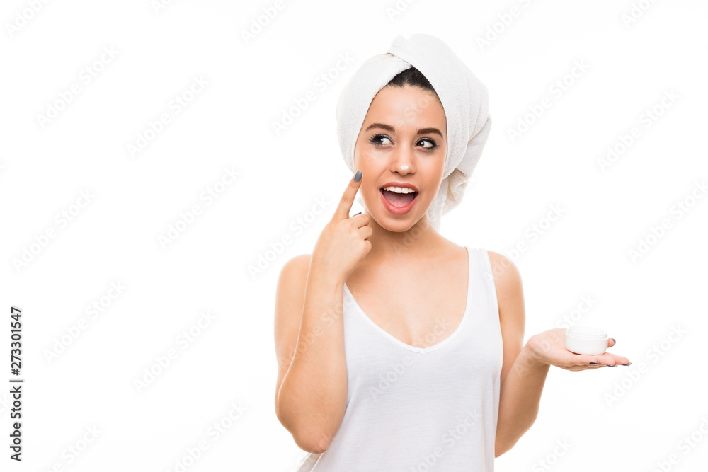Young woman over isolated white background with moisturizer Young woman over isolated white background with moisturizer
