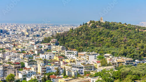 Panorama of Athens with Philopappu or Muse Hill, Greece. It is a tourist attraction of Athens. Scenic view of the Athens city from the famous Acropolis. Urban landscape in summer. Athens skyline. photo