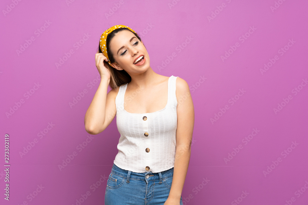 Pretty young woman over isolated purple wall thinking an idea
