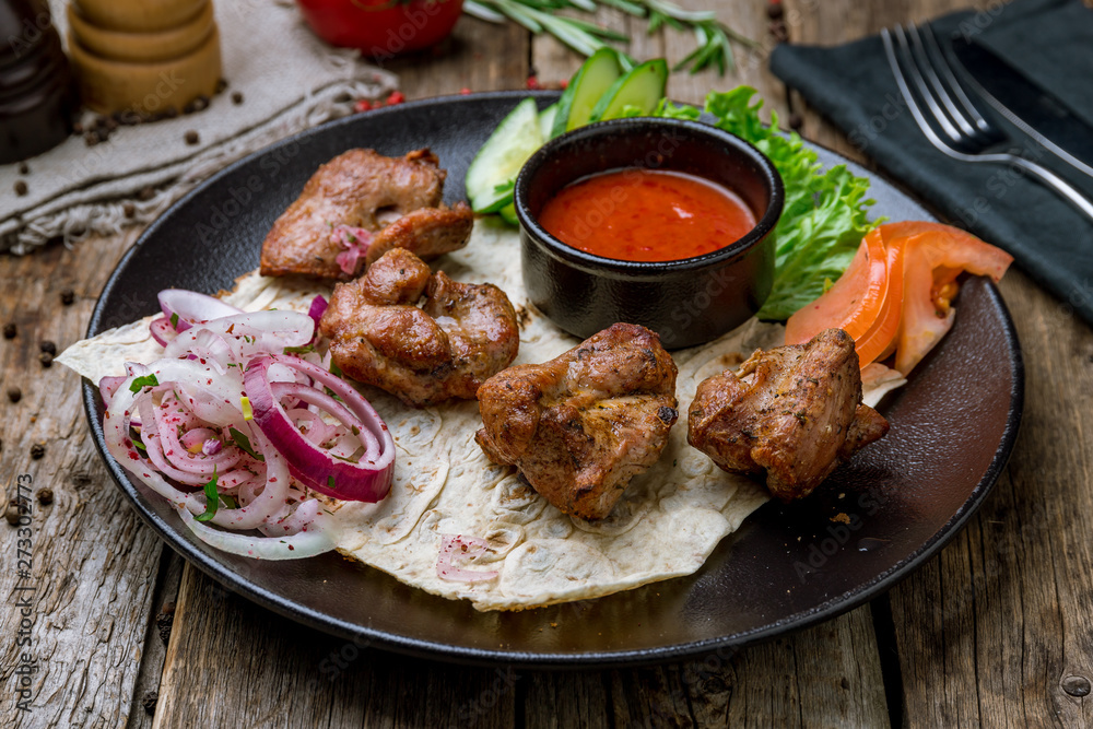 skewers of mutton flesh on black plate skewers of mutton flesh on black plate