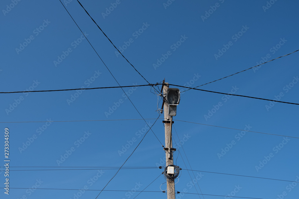 Street lamppost with wires. Concrete pole with a lantern. Street lamp without lamp. Street lamppost with wires. Concrete pole with a lantern. Street lamp without lamp.