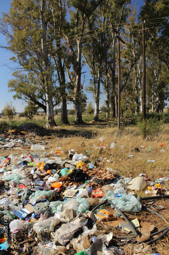 Dump with various type of trash, most of all plastic household rubbish in a meadow near Bloemfontein in South Africa