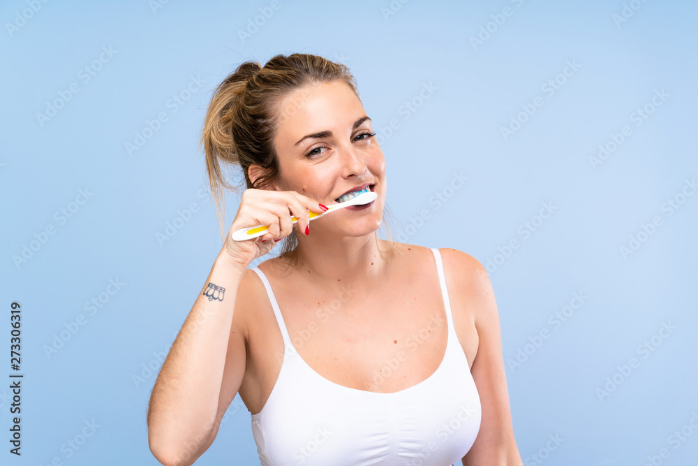 Young blonde woman brushing her teeths Young blonde woman brushing her teeths