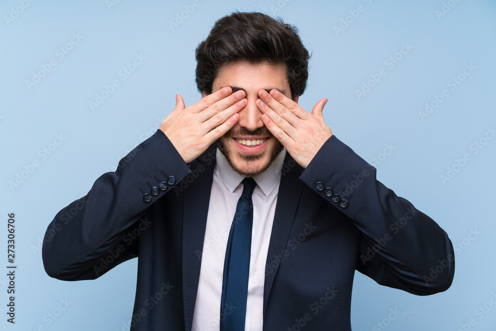 Businessman over isolated blue wall covering eyes by hands Businessman over isolated blue wall covering eyes by hands
