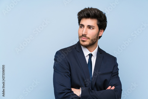 Businessman over isolated blue wall portrait