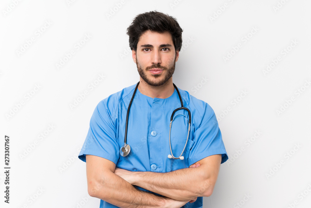 Surgeon doctor man over isolated white wall keeping arms crossed Surgeon doctor man over isolated white wall keeping arms crossed