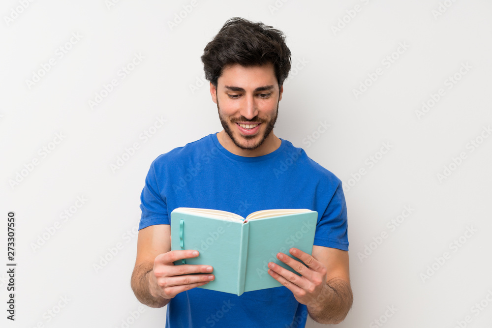 Handsome man holding and reading a book Handsome man holding and reading a book