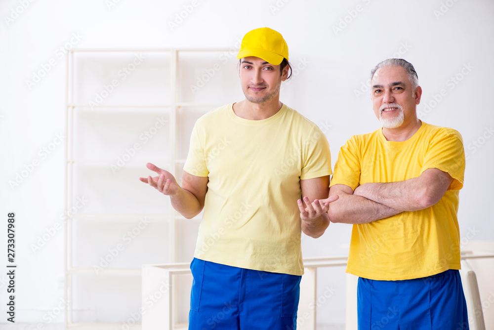 Two contractors carpenters working indoors Two contractors carpenters working indoors