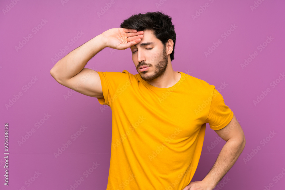 Handsome over isolated purple wall with tired and sick expression Handsome over isolated purple wall with tired and sick expression