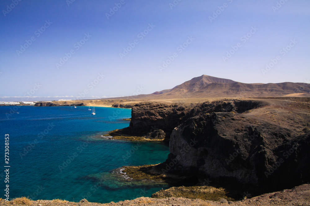 View on steep rugged cliffs of coast of Punta del Papagayo, Playa Blanca - Lanzarote
