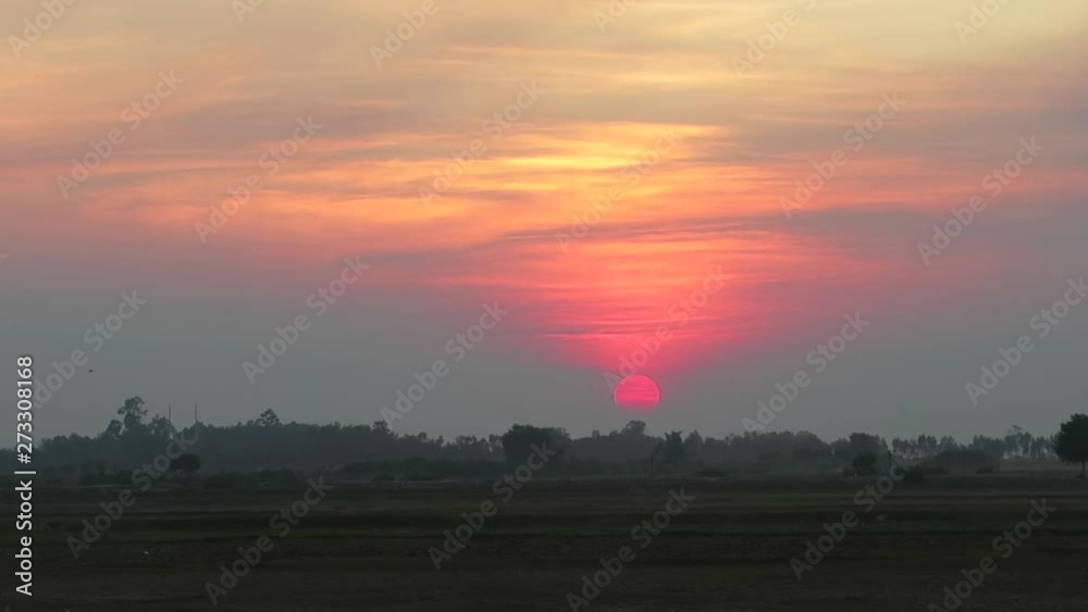 Colorful sunset with birds flying in the countryside Colorful sunset with birds flying in the countryside