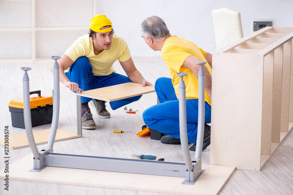 Two contractors carpenters working indoors Two contractors carpenters working indoors