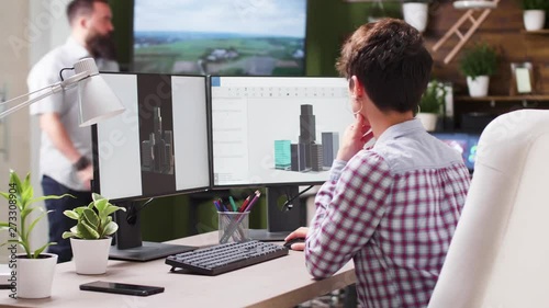 Creative team of engineer and architect talking about new building using 3D software in modern and cozy office