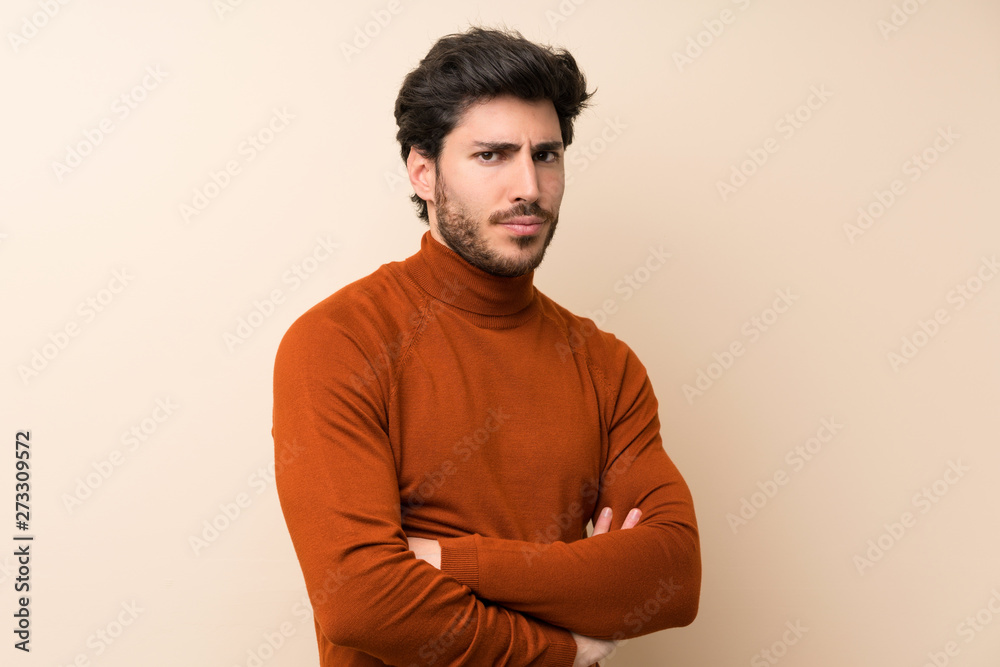 Handsome over isolated wall feeling upset Handsome over isolated wall feeling upset