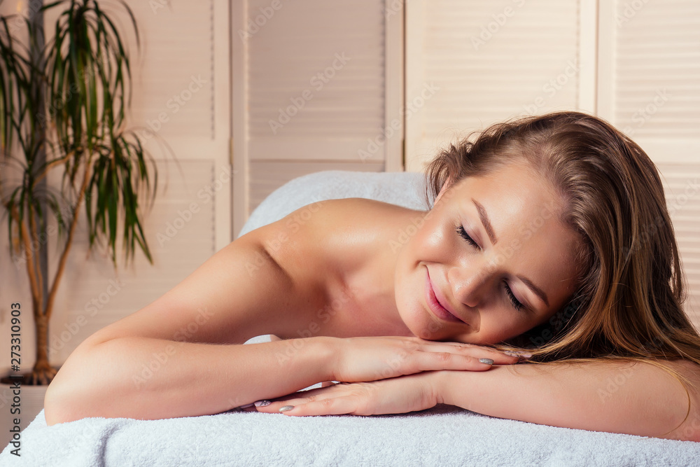 closeup beautiful young woman close eyes getting back massaging